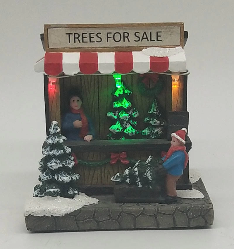 Φωτισμένο χριστουγεννιάτικο κατάστημα στεφανιών με τον άνθρωπο