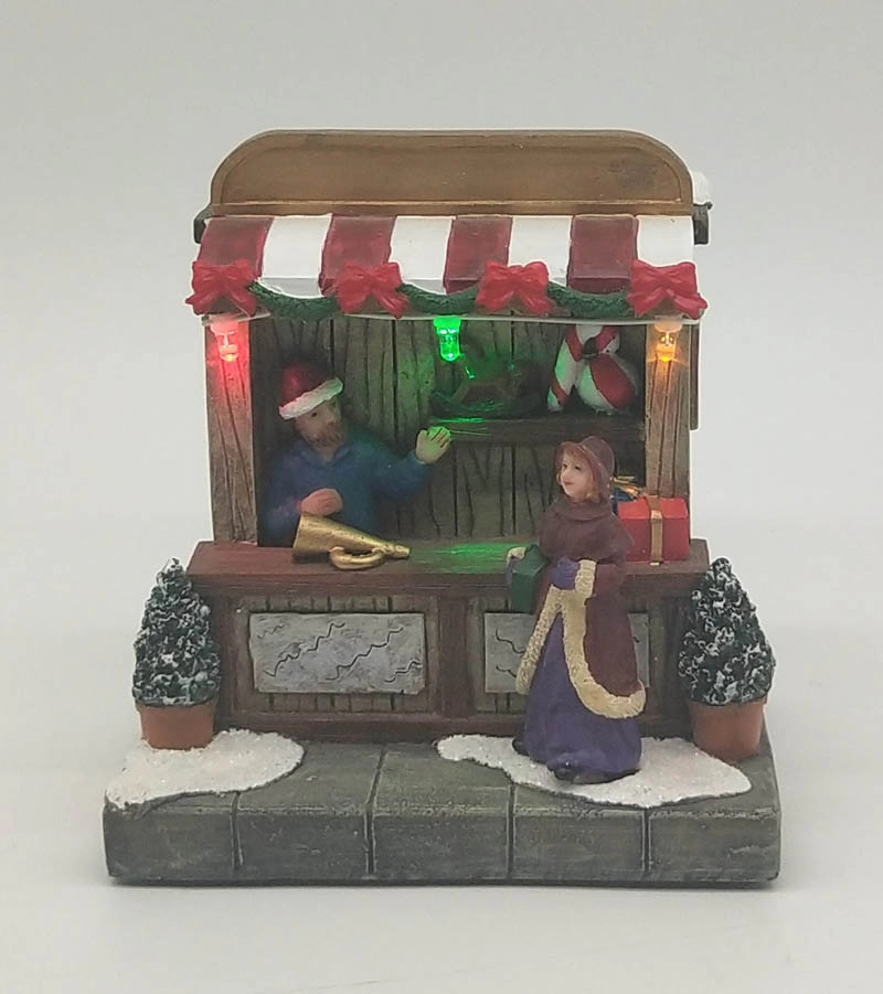 Φωτισμένο χριστουγεννιάτικο κατάστημα παιχνιδιών με γυναίκα
